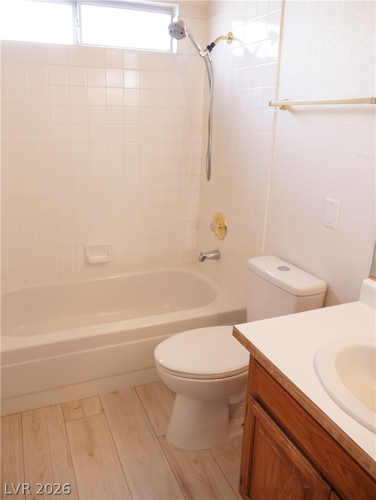 1920 Racine Drive Las Vegas, NV 89156 - Photo 12 of 16 Hall bathroom features classic bathtub and complementing warm wood vanity.