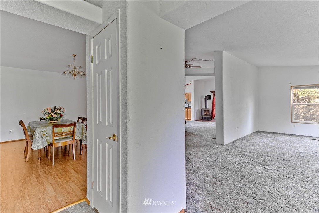 440 Kirkland Road Chehalis, WA 98532 - Photo 11 of 36 a view of a hallway with wooden floor and dining room view