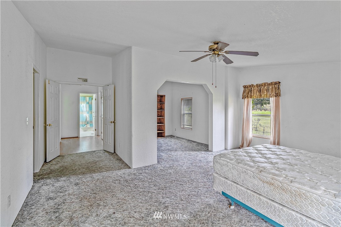 440 Kirkland Road Chehalis, WA 98532 - Photo 13 of 36 a bedroom with a bed and a chandelier
