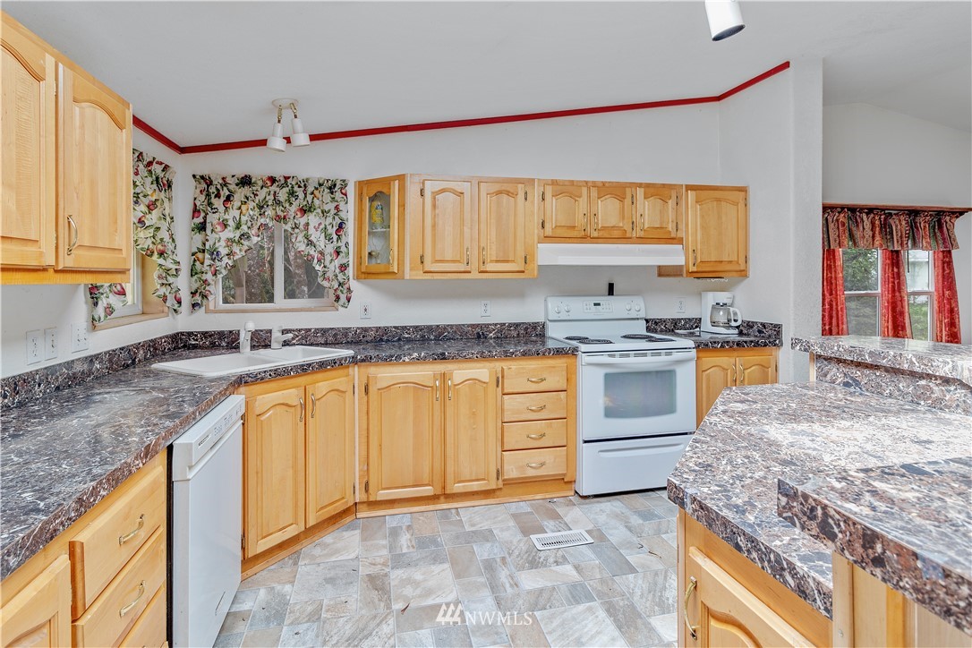 440 Kirkland Road Chehalis, WA 98532 - Photo 3 of 36 a kitchen with granite countertop a sink a counter top space and cabinets