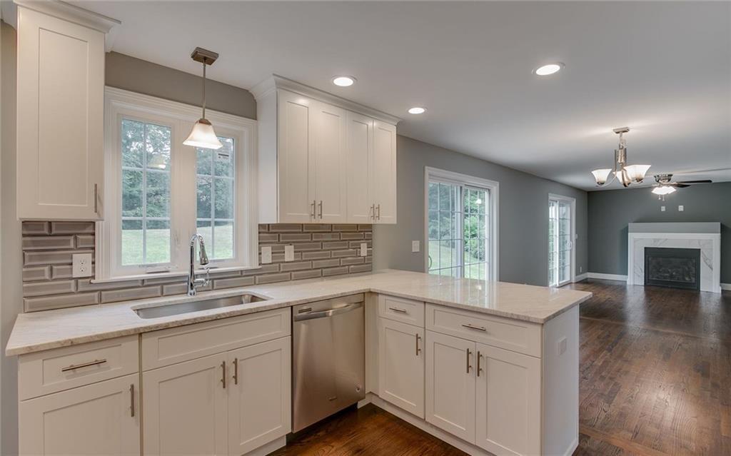 a kitchen with a sink cabinets and window