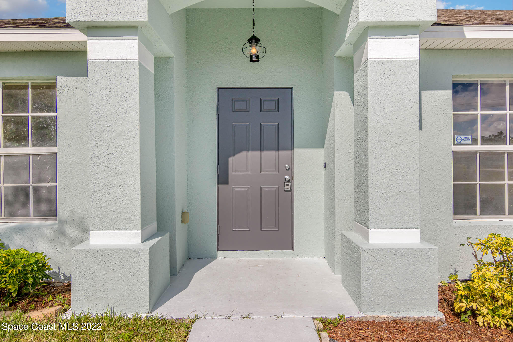 909 San Rafael Road Southwest Palm Bay, FL 32908 - Photo 3 of 24 a front view of a house with a yard