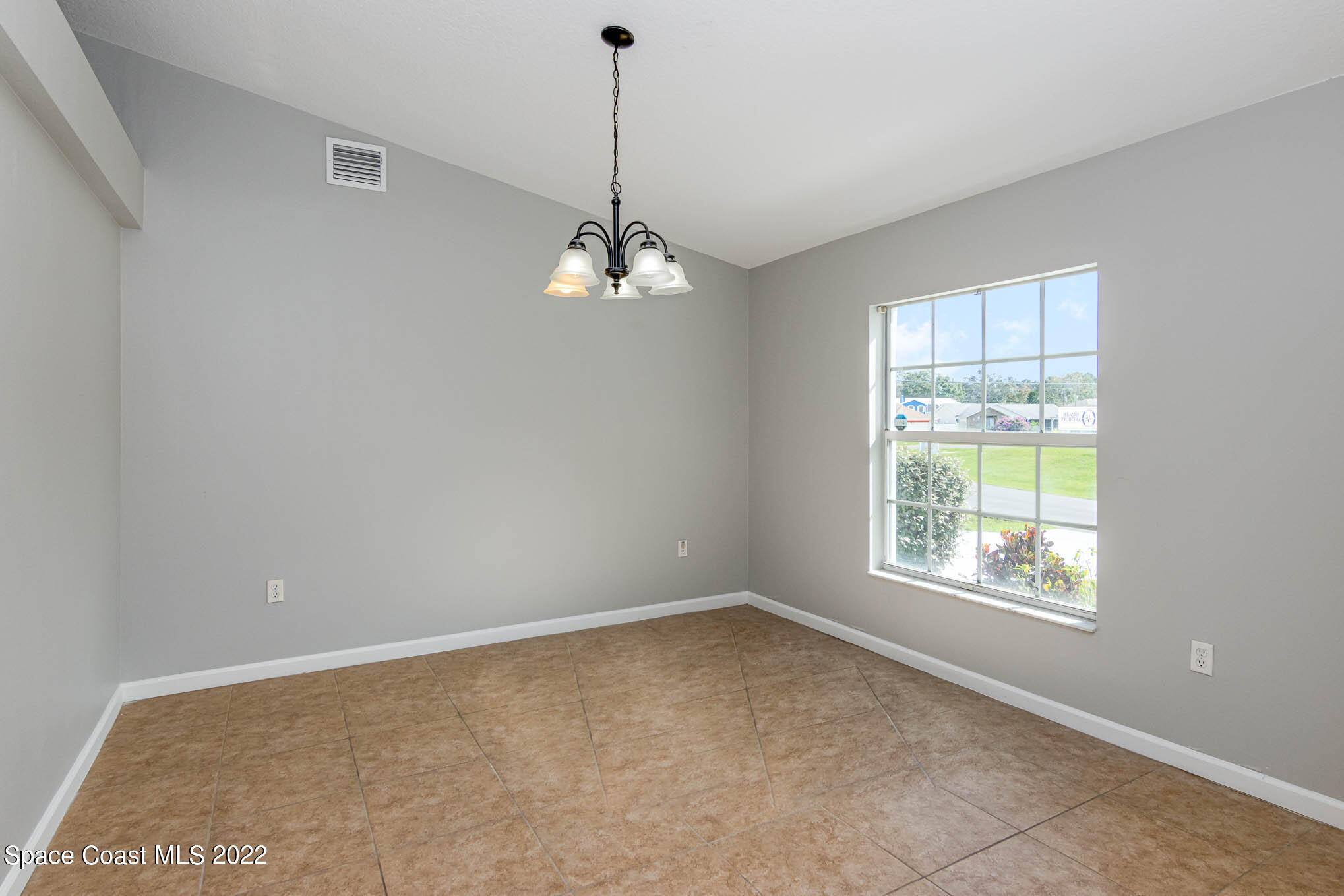 909 San Rafael Road Southwest Palm Bay, FL 32908 - Photo 5 of 24 a view of an empty room with a window