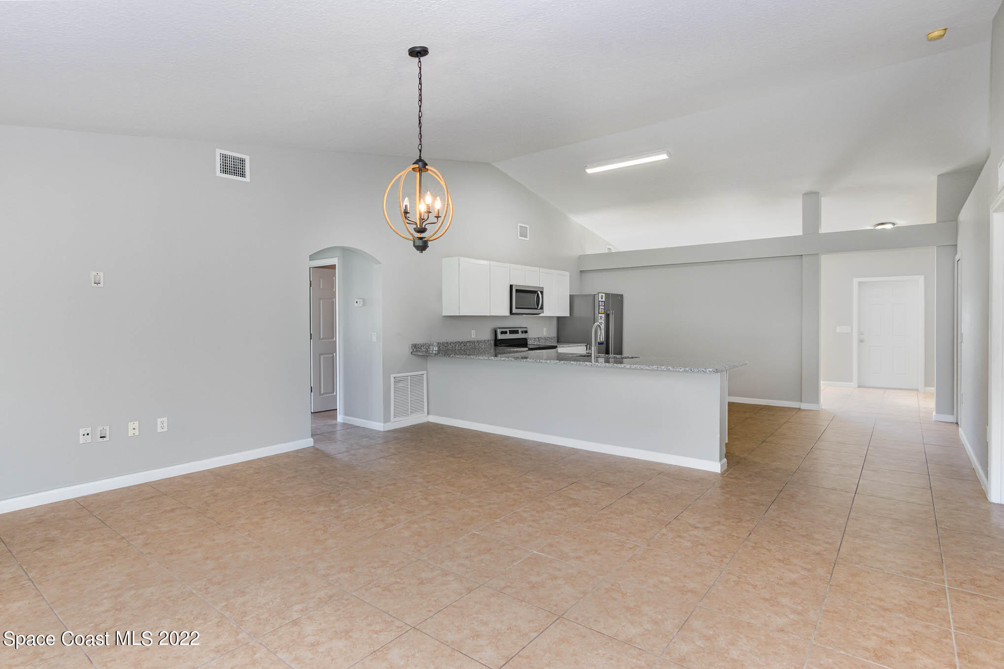 909 San Rafael Road Southwest Palm Bay, FL 32908 - Photo 7 of 24 a view of a kitchen with a sink and chandelier window