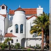 a front view of a house with a parking space