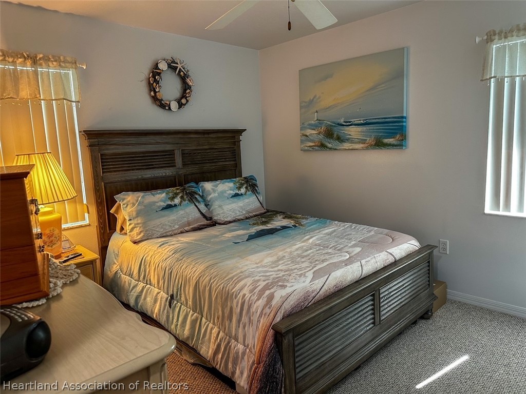 4428 Loquat Road Sebring, FL 33875 - Photo 23 of 29 a bedroom with a bed and painting on the wall