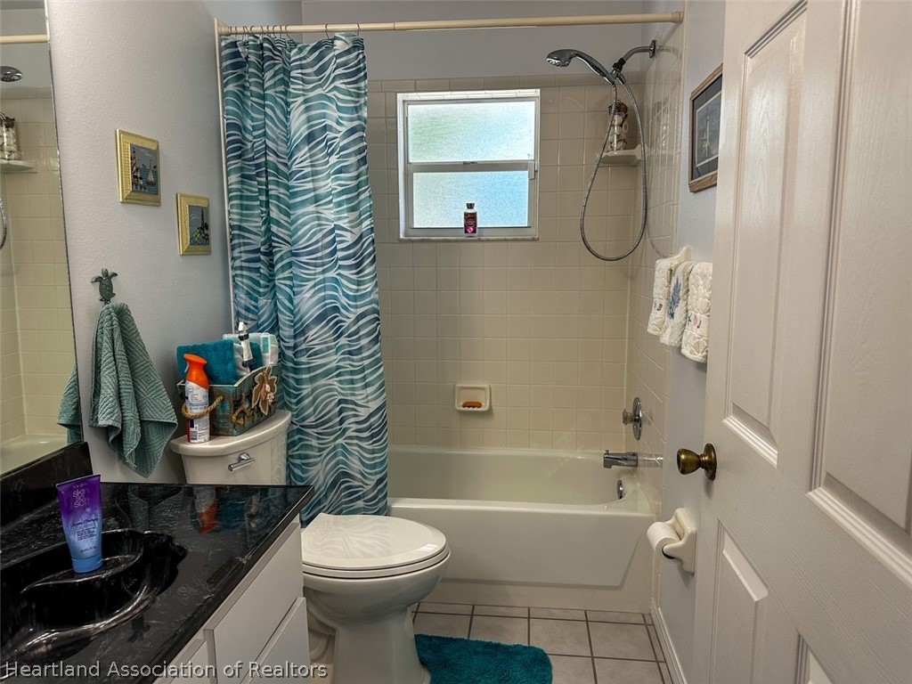 4428 Loquat Road Sebring, FL 33875 - Photo 26 of 29 a bathroom with a toilet a sink and shower curtain