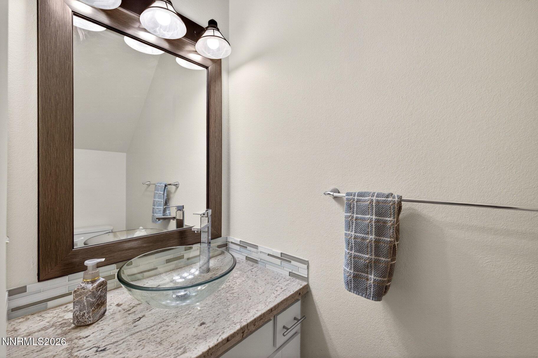 3415 Balboa Drive Reno, NV 89503 - Photo 15 of 61 a bathroom with a granite countertop sink a mirror and shower