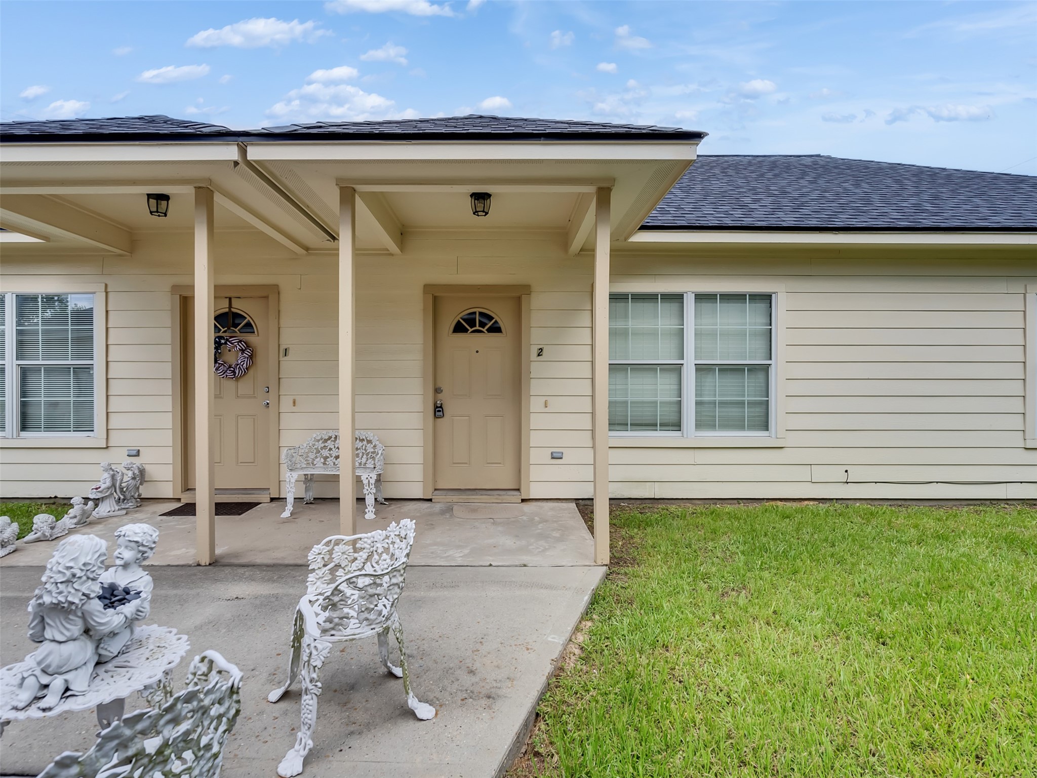 104 Longstreet Road, Unit 2 Willis, TX 77378 - Photo 1 of 26 a front view of a house with patio