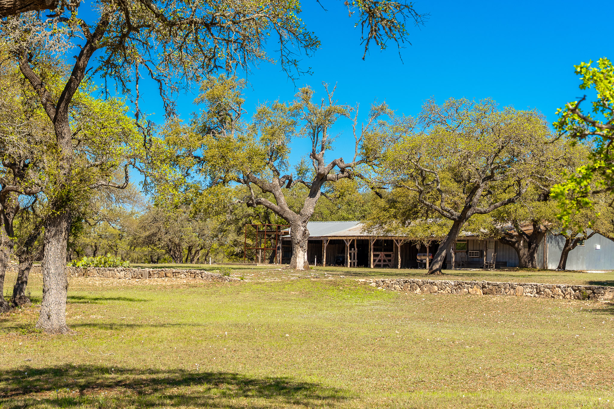 1100 Pump Station Road Wimberley, TX 78676 - Photo 37 of 40 a front view of a house with a large tree