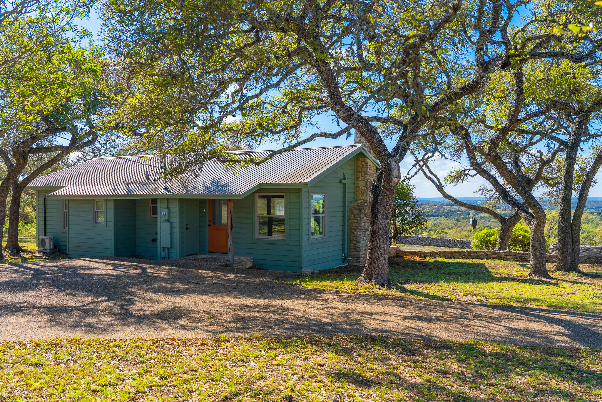 1100 Pump Station Road Wimberley, TX 78676 - Photo 8 of 40 a front view of a house with a yard