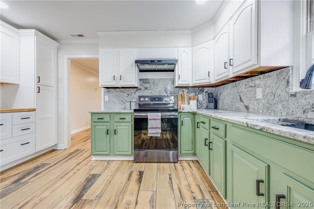 1250 Overhills Road Linden, NC 28356 - Photo 11 of 34 a kitchen with stainless steel appliances granite countertop a stove and cabinets