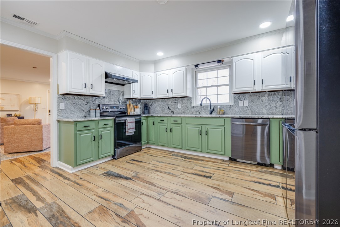 1250 Overhills Road Linden, NC 28356 - Photo 12 of 34 a kitchen with a refrigerator sink and cabinets