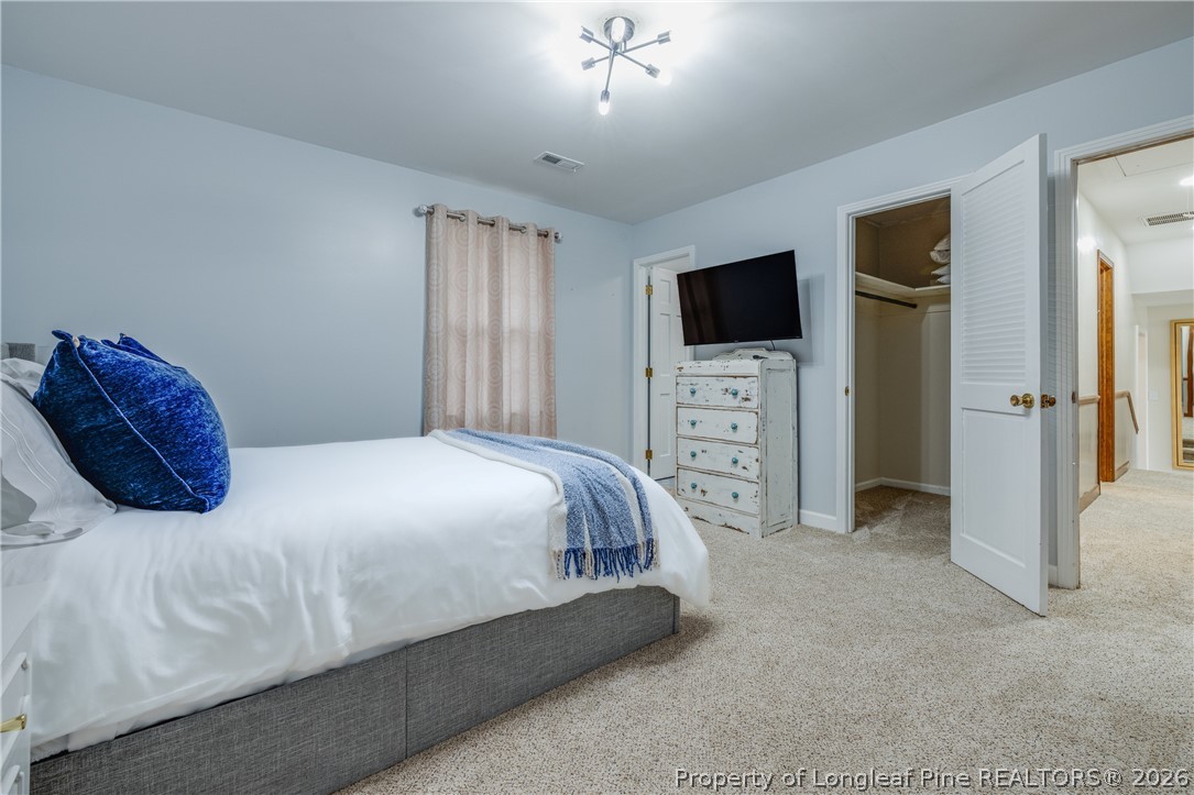 1250 Overhills Road Linden, NC 28356 - Photo 19 of 34 a bedroom with a bed and a flat screen tv