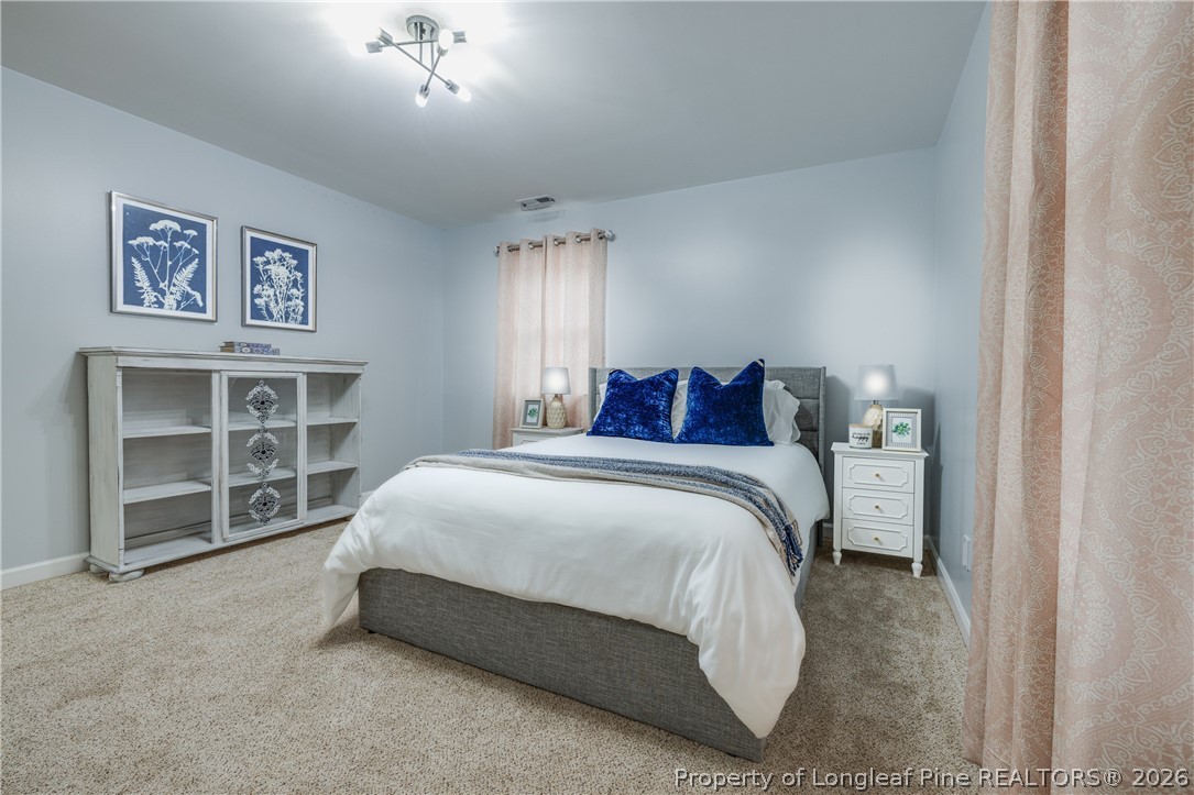 1250 Overhills Road Linden, NC 28356 - Photo 20 of 34 a spacious bedroom with a bed and a window