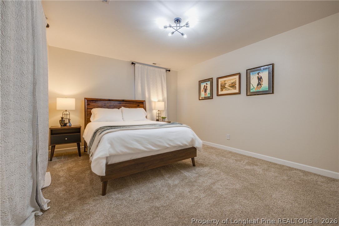 1250 Overhills Road Linden, NC 28356 - Photo 22 of 34 a bedroom with a bed and a table
