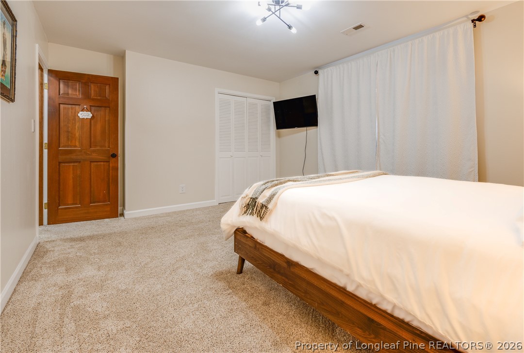 1250 Overhills Road Linden, NC 28356 - Photo 23 of 34 a spacious bedroom with a bed and a view of bathroom