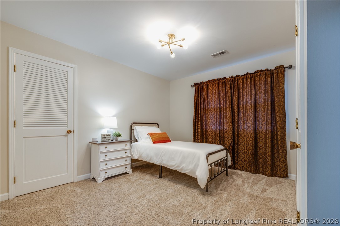 1250 Overhills Road Linden, NC 28356 - Photo 24 of 34 a bedroom with furniture and a chandelier