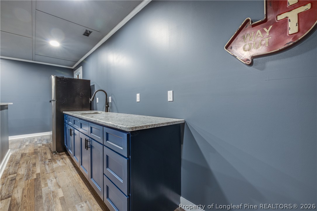 1250 Overhills Road Linden, NC 28356 - Photo 31 of 34 a kitchen with kitchen island a sink stove and a refrigerator