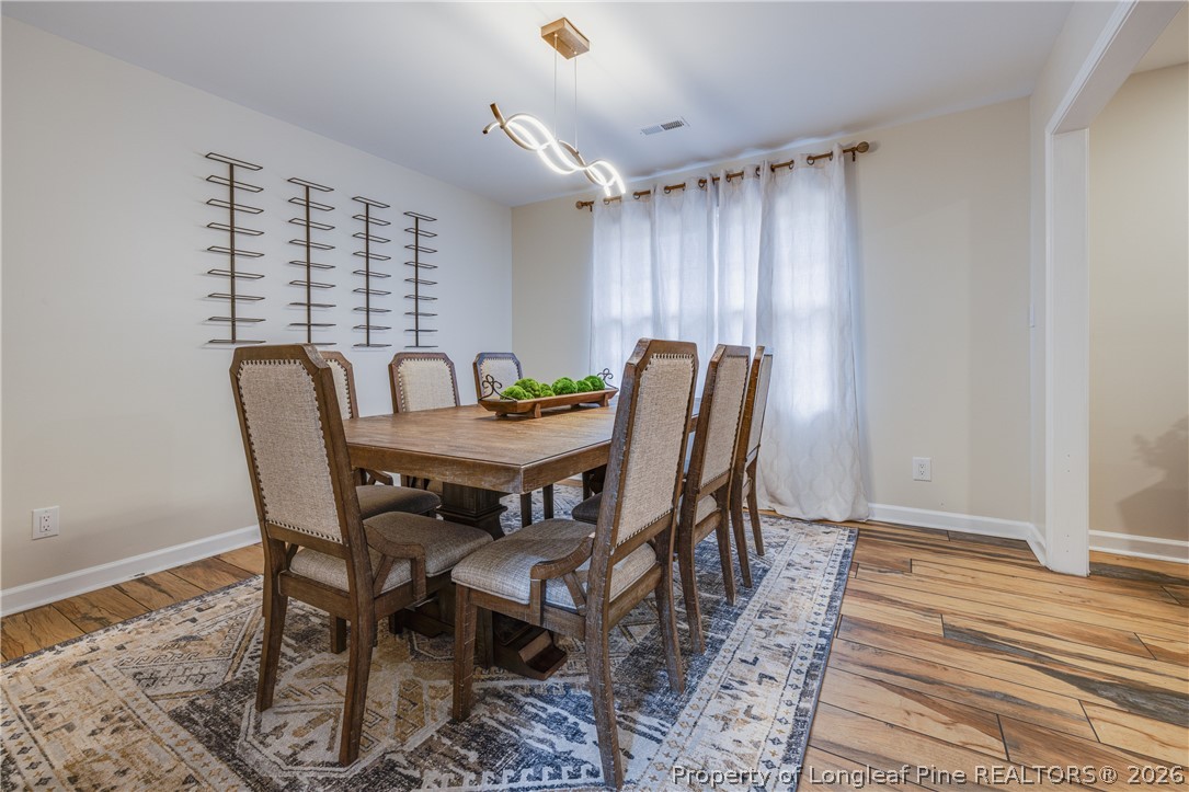 1250 Overhills Road Linden, NC 28356 - Photo 8 of 34 a view of a dining room with furniture window and wooden floor