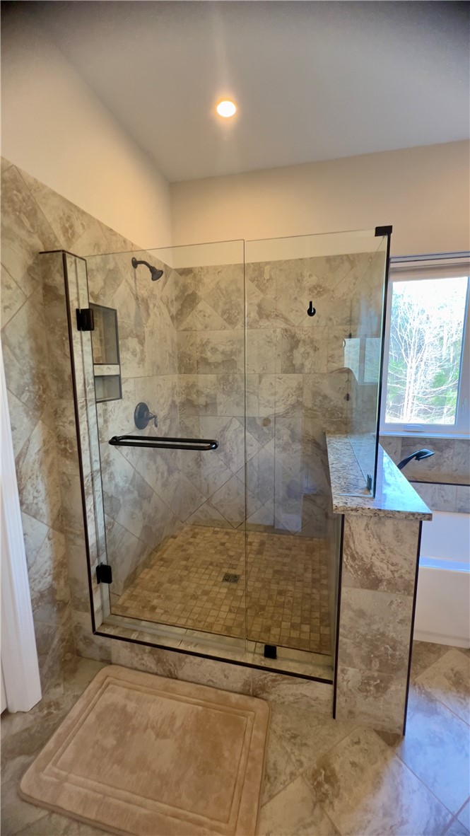 160 Hudgins Lake Road Townville, SC 29689 - Photo 24 of 41 A generously sized walk-in shower with elegant tile work and a window offering natural light.