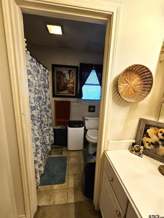 a toilet sitting next to a small bathroom