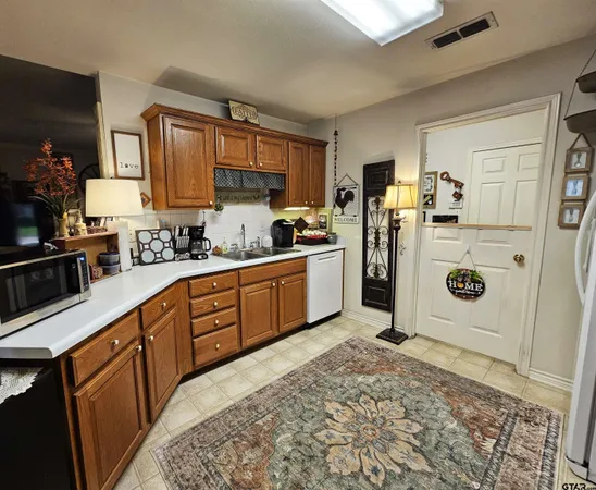 a kitchen with stainless steel appliances granite countertop a refrigerator sink and cabinets