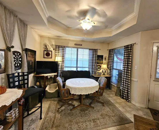 a living room with furniture a dining table and a window