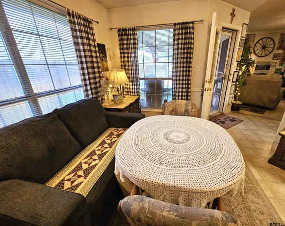 a living room with furniture and a floor to ceiling window