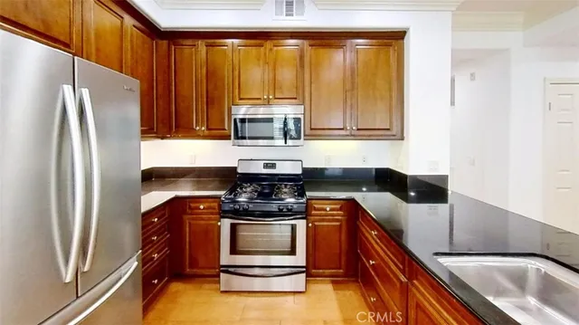 a kitchen with a refrigerator and a sink