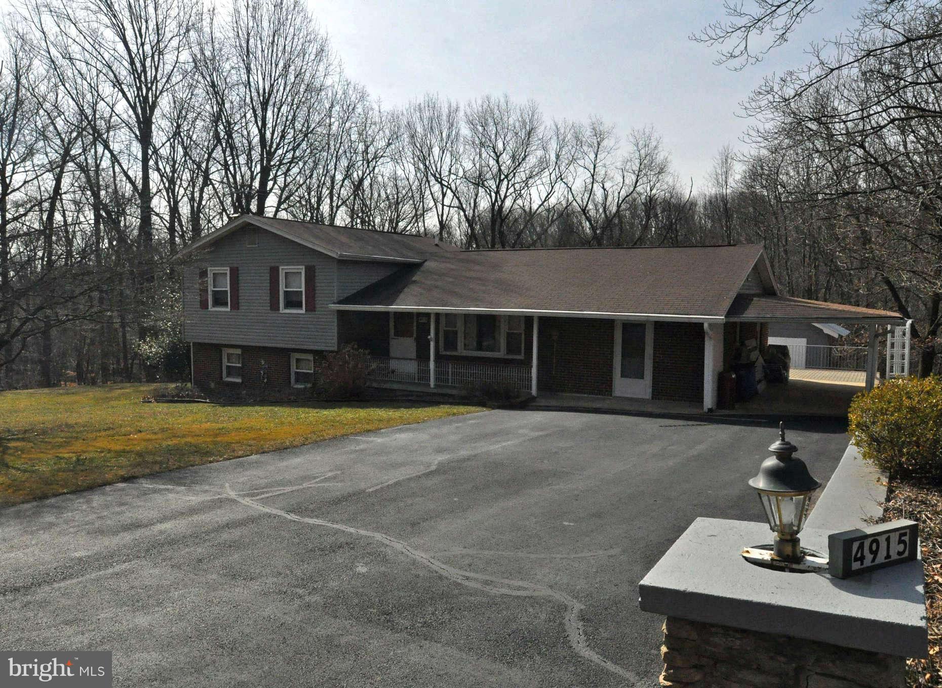 4915 Mt Zion Road Frederick, MD 21703 - Photo 1 of 30 a front view of a house with a yard and garage