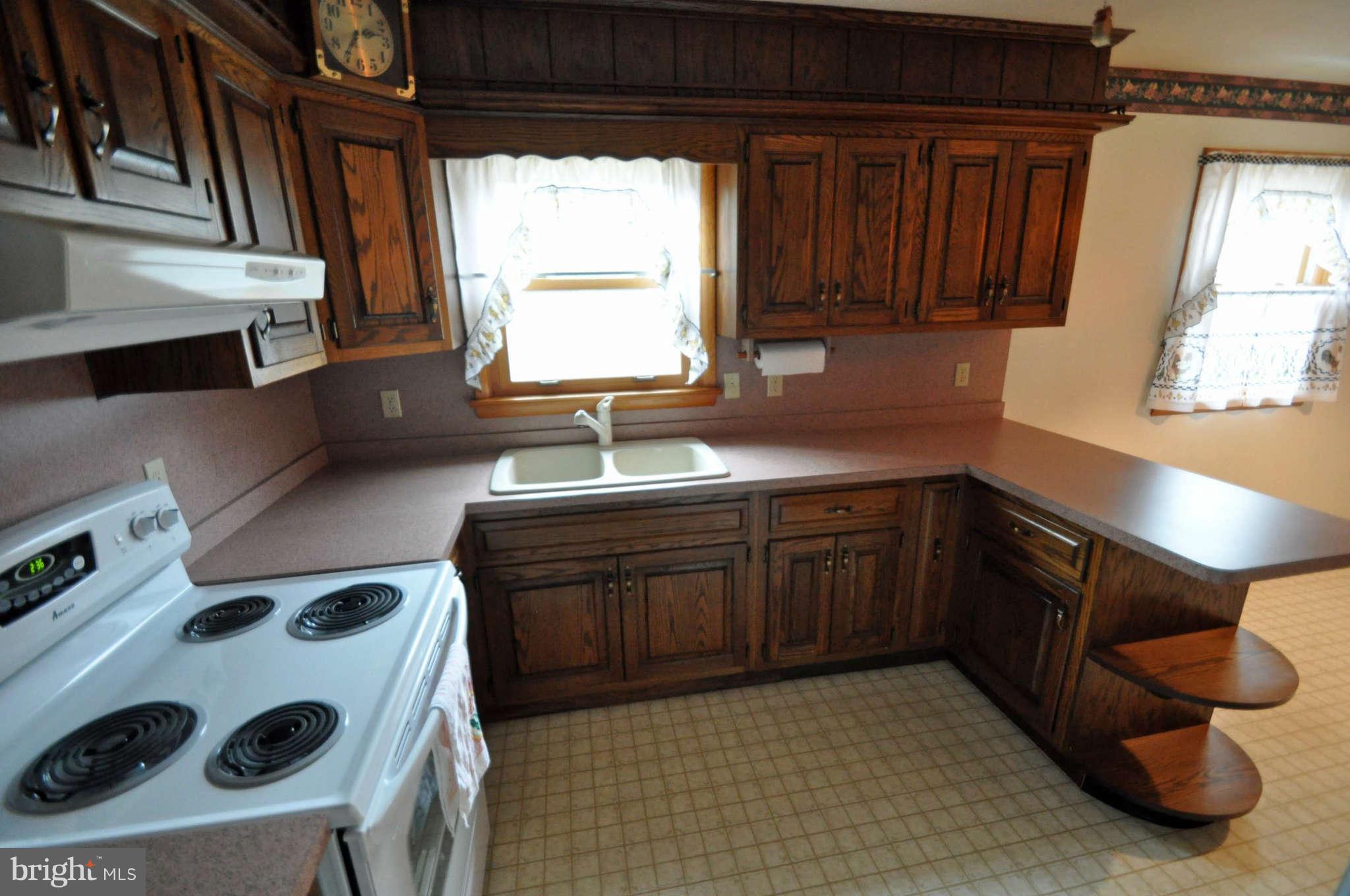4915 Mt Zion Road Frederick, MD 21703 - Photo 12 of 30 a kitchen with a sink a stove and cabinets