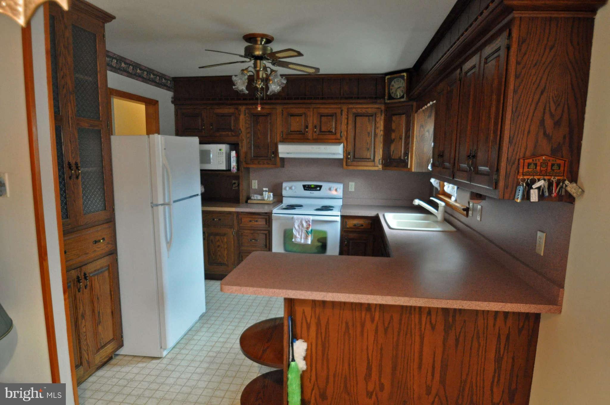 4915 Mt Zion Road Frederick, MD 21703 - Photo 14 of 30 a kitchen with stainless steel appliances granite countertop a refrigerator a stove and a sink