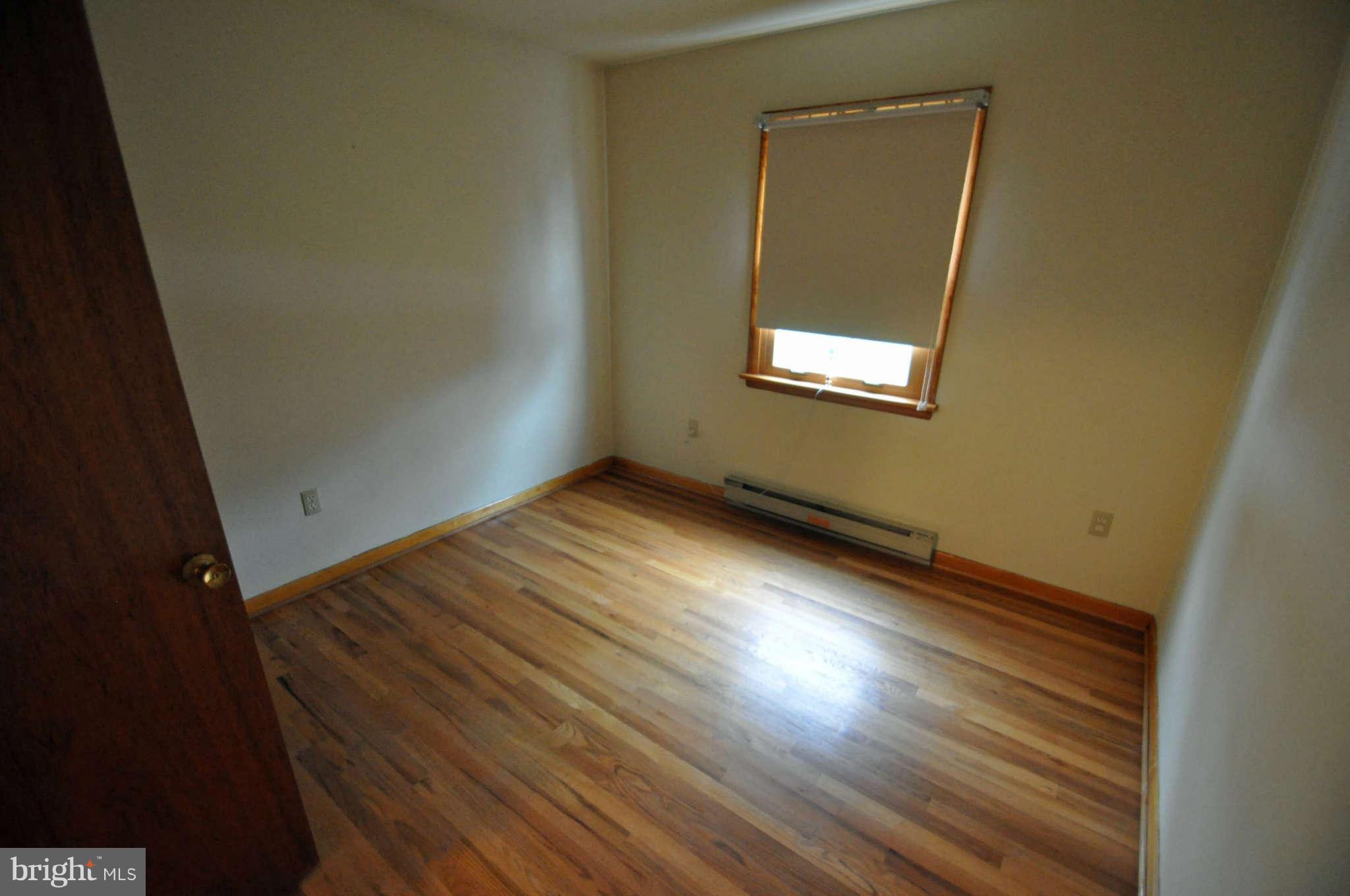 4915 Mt Zion Road Frederick, MD 21703 - Photo 21 of 30 an empty room with wooden floor and windows