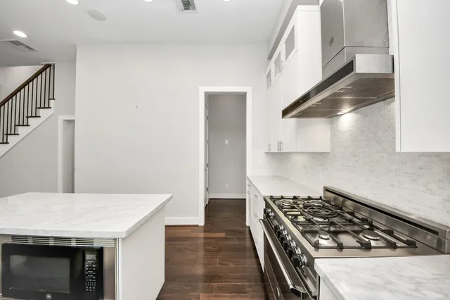 a kitchen with a stove and a refrigerator