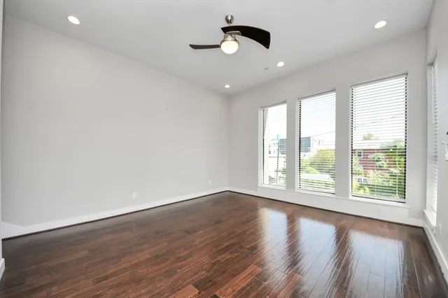 a bedroom with a large bed and a large window