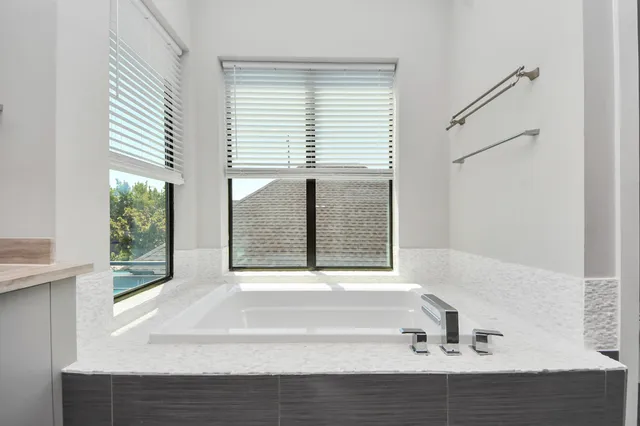 a bathroom with double sink and a large mirror