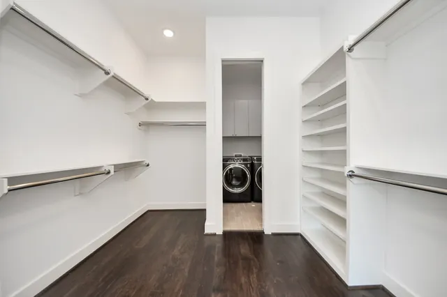 a view of walk in closet with empty racks