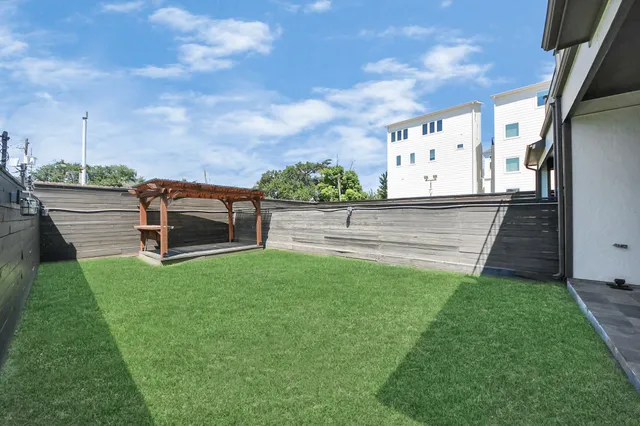 a backyard of a house with table and chairs