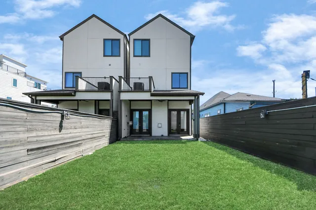 a view of a house with a yard and sitting area