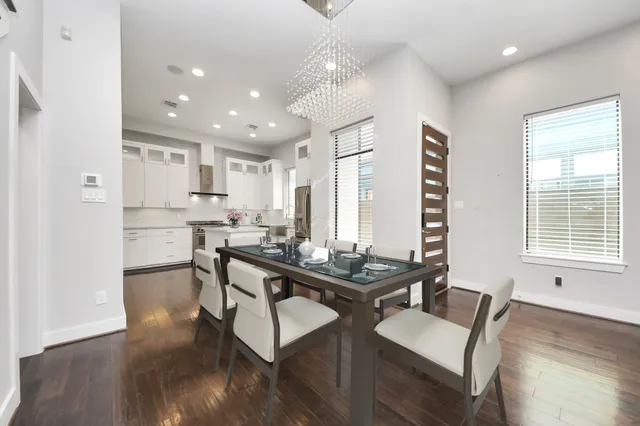 a view of empty room with wooden floor and windows
