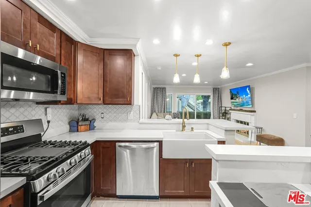 a kitchen with stainless steel appliances a sink stove and cabinets