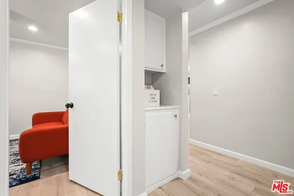 a view of hallway with livingroom and a workspace