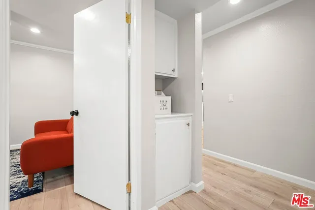 a view of hallway with livingroom and a workspace