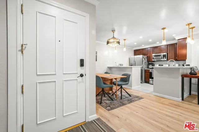 a kitchen with stainless steel appliances kitchen island granite countertop a refrigerator and microwave