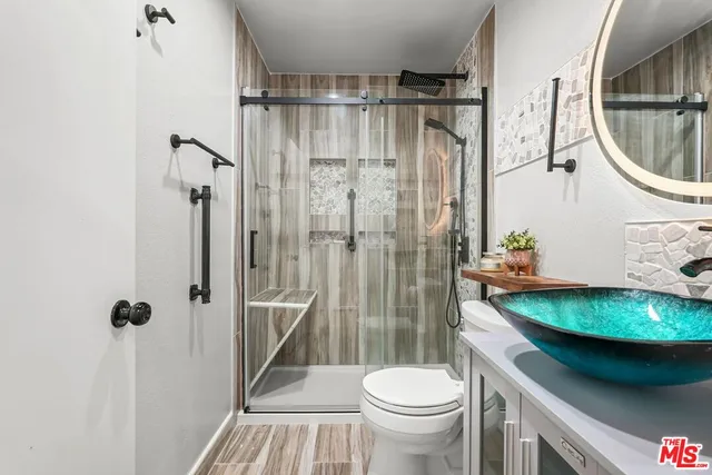 a bathroom with a sink toilet and shower