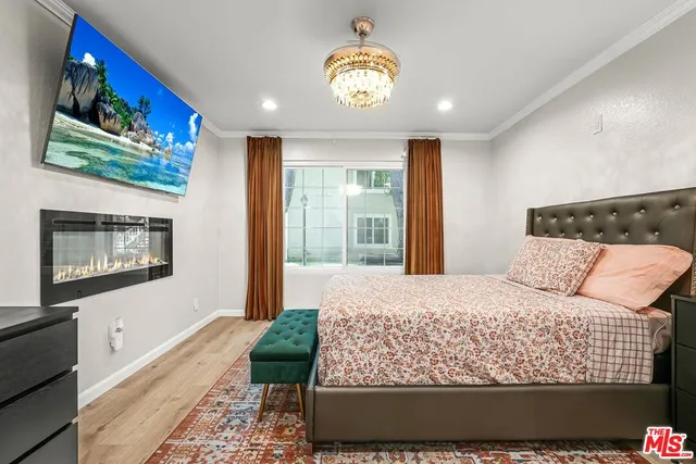 a bedroom with a large bed and a chandelier