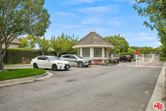 a couple of cars parked in front of a house