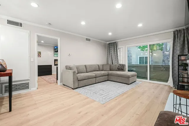 a living room with furniture and a floor to ceiling window