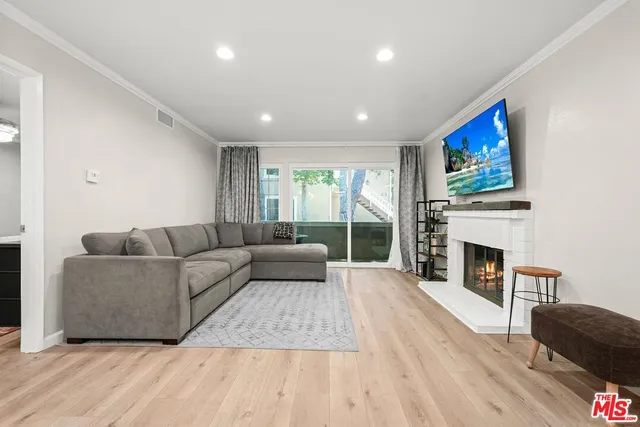 a living room with furniture a fireplace with wooden floor